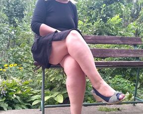 Lustful MILF pissing while sitting on a bench